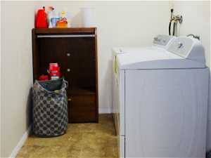 Laundry area featuring independent washer and dryer, light tile floors, and hookup for a washer/dryer.