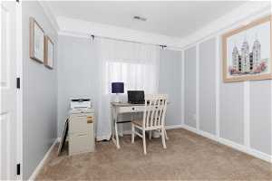 Office area featuring crown molding and light carpet