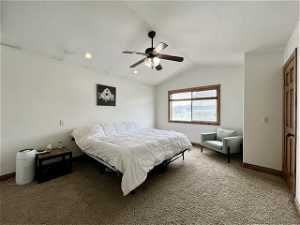 Owners bedroom featuring vaulted ceiling and ceiling fan