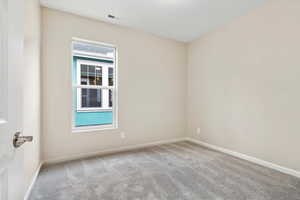 Unfurnished room featuring carpet