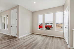 Unfurnished room featuring plenty of natural light and light wood-type flooring