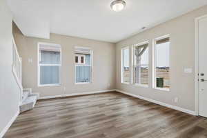 Spare room with light hardwood / wood-style floors and plenty of natural light