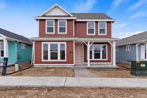 View of front of house with central AC