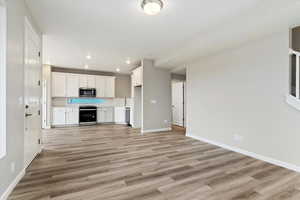 Unfurnished living room with light wood-type flooring