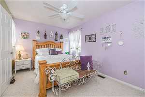 Bedroom  2 with light colored carpet and ceiling fan