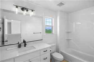 Full bathroom featuring vanity, toilet, and shower / bathing tub combination