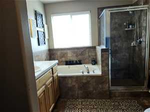 Master Bathroom featuring tile floors, vanity, and independent shower and bath