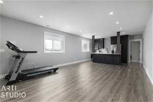 Workout room with dark hardwood / wood-style flooring and sink
