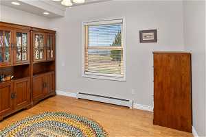Sitting room featuring light hardwood / wood-style floors and a baseboard heating unit