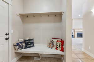 Mudroom featuring light tile flooring