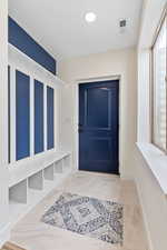 Mudroom with light tile floors