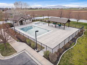 View of pool featuring a gazebo, a mountain view, a patio area