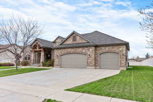 View of front of property with a front lawn and a garage