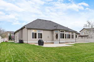 Back of property featuring central AC, a yard, and a patio