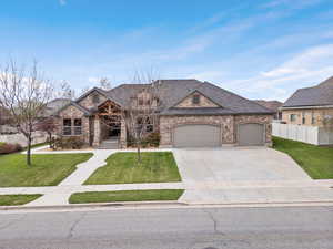 View of front of home with a front yard and a garage