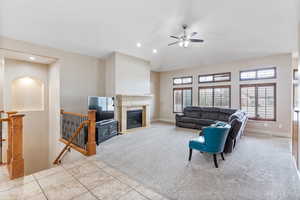 Family room featuring ceiling fan and a fireplace