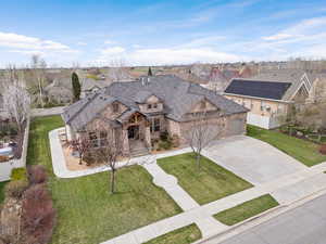 View of front of property featuring a front lawn and a garage