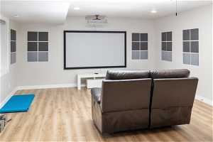 Cinema room featuring light wood-type flooring