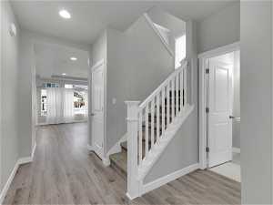 Stairs featuring light hardwood / wood-style floors