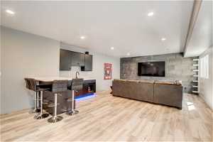 Living room featuring bar area and light hardwood / wood-style floors