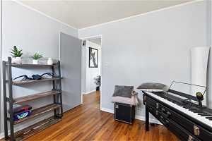 Bedroom 2 room with ornamental molding and dark hardwood / wood-style floors