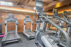 Workout area featuring wood walls