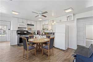 *Virtually Staged* Dining area featuring light hardwood / wood-style flooring, ceiling fan, and sink