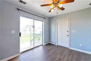 Interior space featuring a baseboard radiator, dark hardwood / wood-style floors, and ceiling fan