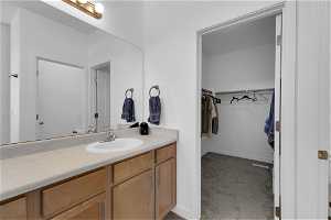 Bathroom with vanity, walk in closet