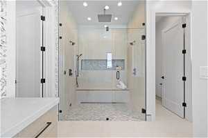 Bathroom with tile floors and a shower with door