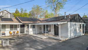 Exterior showing entrances to units 4 & 5. Entrance for unit 3 is out of photo on left. Solar panels