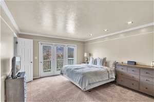 Bedroom featuring ornamental molding, light colored carpet, and access to exterior