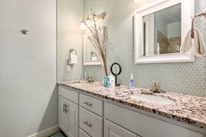 Bathroom featuring dual sinks and oversized vanity