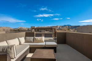 View of terrace with a balcony, a red rock Mountain View, and an outdoor living space