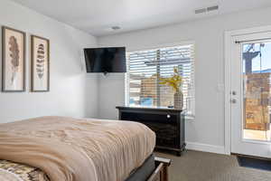 Bedroom featuring dark carpet