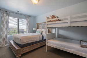 Bedroom featuring dark carpet