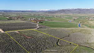 Aerial overview of property's location featuring property boundaries highlighted and a mountainous background
