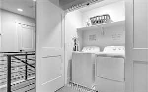 Laundry room with light tile flooring and separate washer and dryer