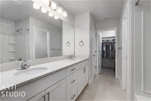 Bathroom with double sink, tile floors, and oversized vanity