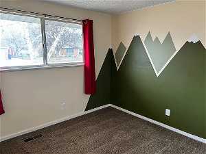 Bedroom 2, textured ceiling, new carpet, feature wall