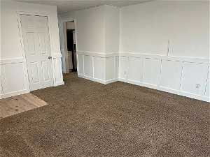 Living/family room, coat closet, wainscoting, new carpet, natural light