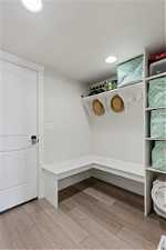 Mudroom with a textured ceiling and light wood-type flooring