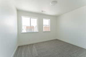 Unfurnished room featuring carpet