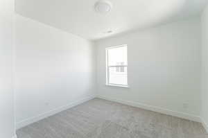 Unfurnished room with light carpet