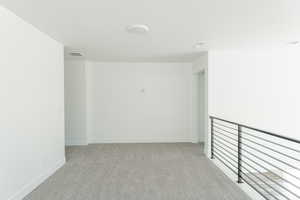 Empty room with light colored carpet