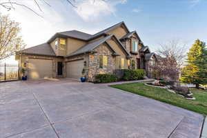 Craftsman-style house with a front lawn and a garage