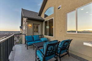 Balcony at dusk featuring an outdoor living space