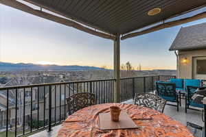 Balcony at dusk featuring an outdoor hangout area