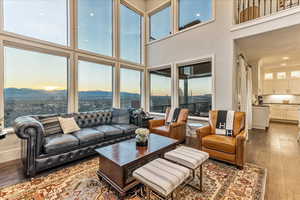 Living room with engineered hardwood flooring and a high ceiling