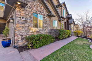 View of side of home featuring a yard and a garage